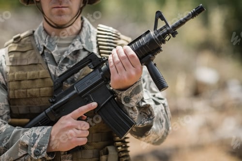 Preview: Confident military soldier standing with rifle