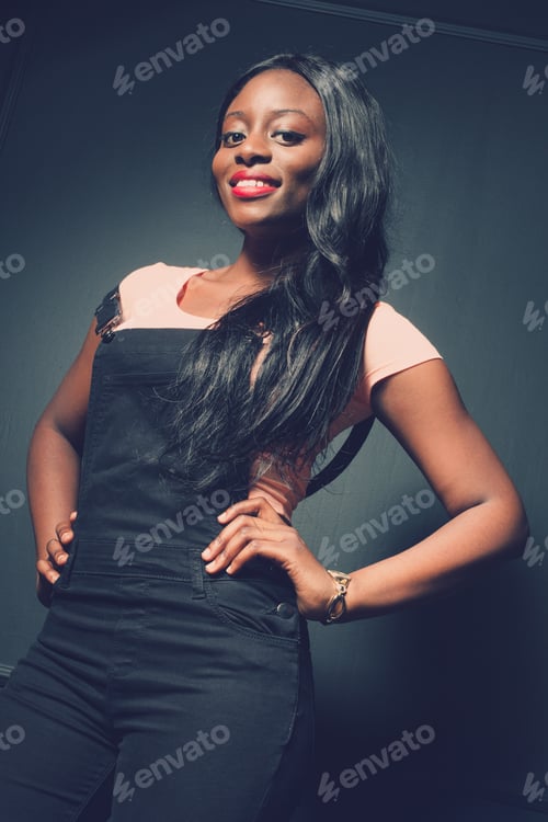 Preview: Model posing confidently in stylish outfit against dark background