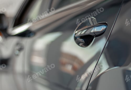 Preview: Close up photo of grey car door handle in autoshow