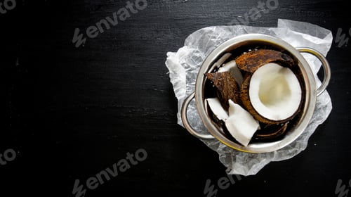 Preview: Coconut in metal bowl on the chalkboard . Free space for text.