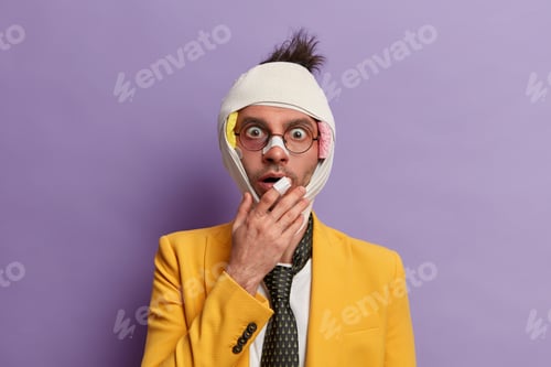 Preview: Scared impressed man covers mouth and stares with fear, leads crimimal life, got bruises on face aft