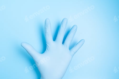Preview: Medical Glove Against a Blue Background