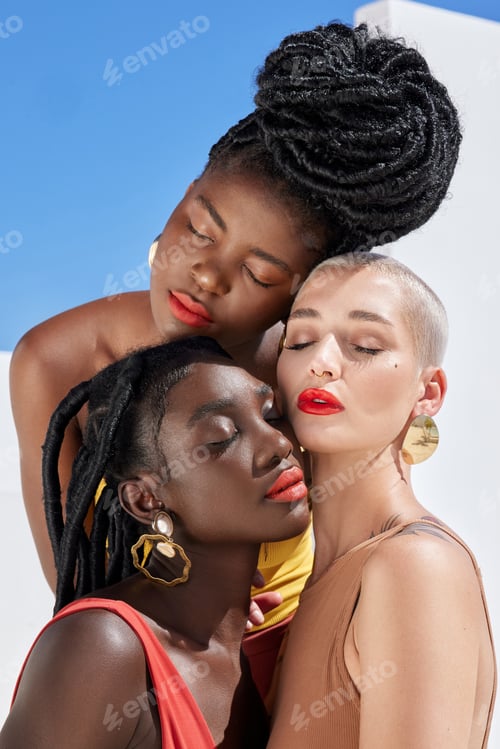 Preview: Cropped shot of three attractive young women posing on a rooftop outdoors