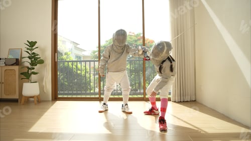 Preview: Before the tournament day, a boy and girl dressed in fencing gear are rehearsing in gym