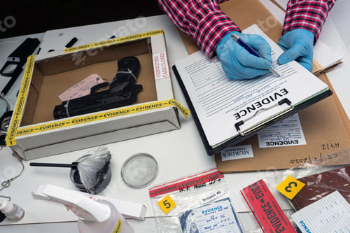 Preview: Close up of forensic science evidence box containing gun from crime scene, conceptual image