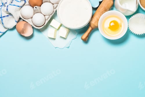 Preview: Baking ingredients at blue table top view
