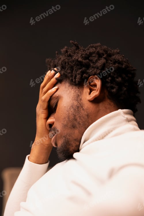 Preview: Distressed person placing palm on forehead, feeling pain and pressure
