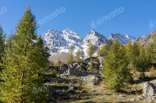 Preview: Rocky landscape with snowy mountain peak in the distance on a sunny day