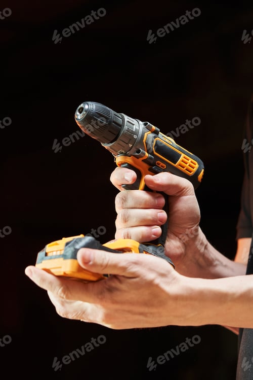 Preview: Cordless Drill Tool Held by Hand in Dark