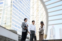 Preview: Asian Businesspeople discussing work in modern city setting