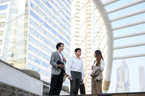 Preview: Asian Businesspeople discussing work in modern city setting