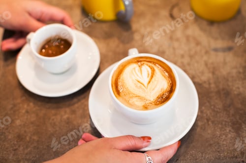 Preview: Woman holding coffee cup