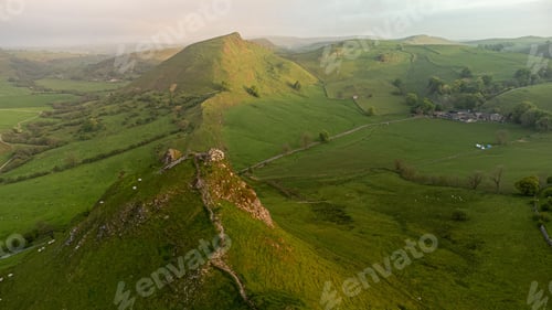 Preview: Scenic view of a rocky landscape covered with hills at sunset