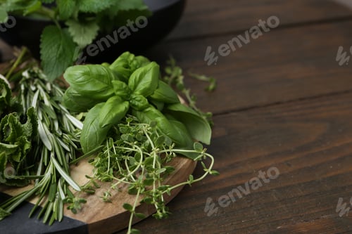 Preview: Different fresh green herbs on wooden table, closeup. Space for text
