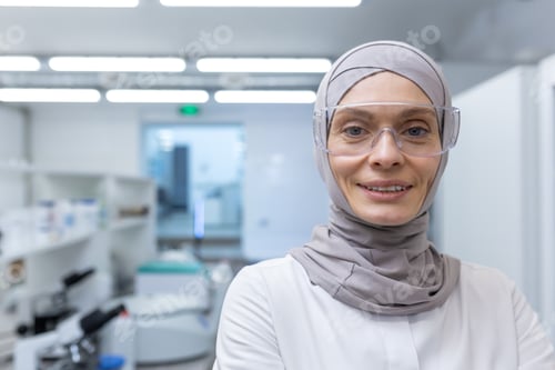 Preview: Close-up photo. Portrait of a young Muslim female lab assistant, pharmacist, scientist in hijab and