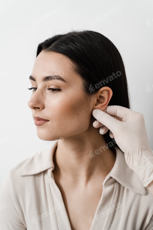 Preview: Otoplasty ear surgery preoperative examination of girl's ears by surgeon for pinna correction