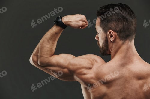 Close up of a muscular bodybuilder flexing biceps