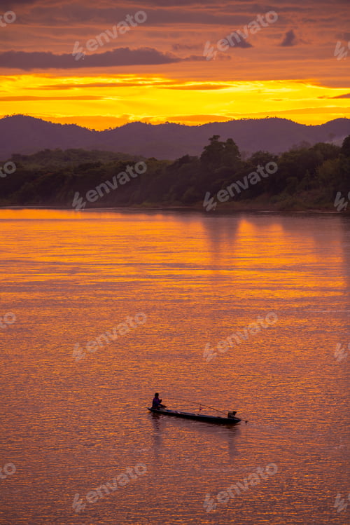 Preview: Fishing man on wood boat in lake sunset