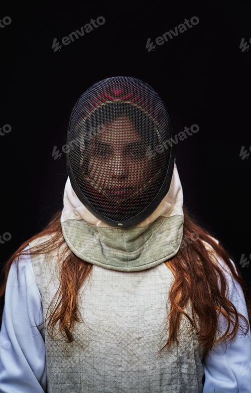 Preview: Portrait of woman dressed in fencing costume on black background
