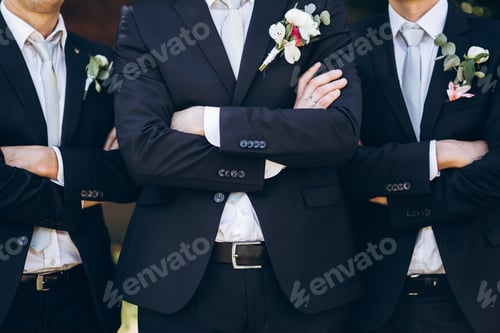 Preview: Stylish groom in suit posing with groomsmen in garden on wedding day