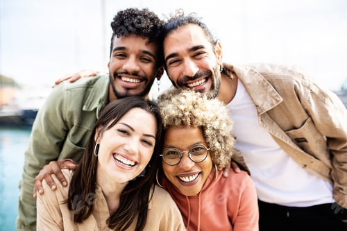 Preview: Group portrait of four multiracial united friends outdoors