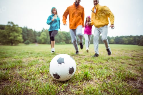 Vista previa: Friends running towards football in the countryside