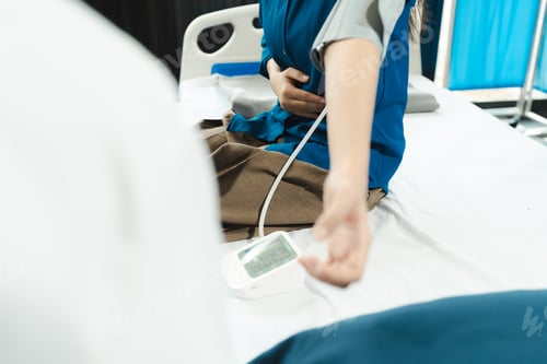 Preview: male doctor having blood pressure test, woman at the clinic in the morning.