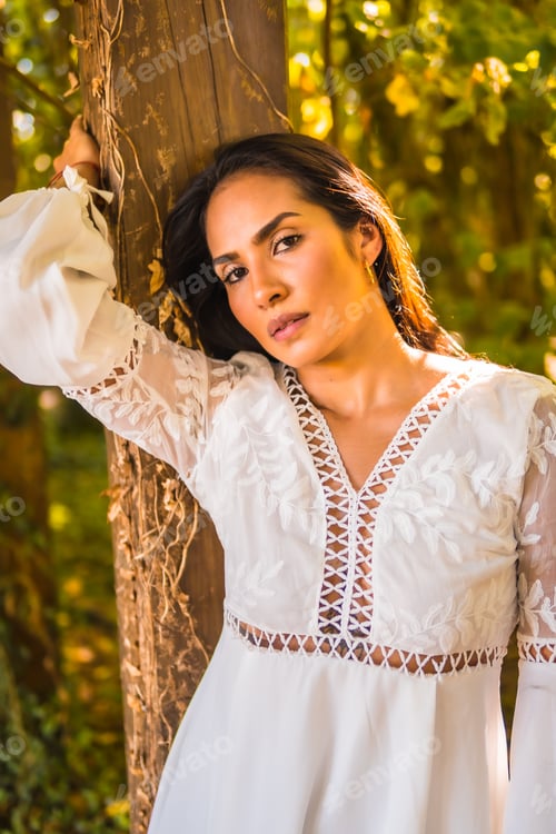 Preview: Lifestyle, brunette girl with straight hair in a beautiful white dress in a park