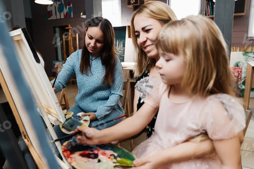 Preview: A mother and daughter enjoy painting together in a cozy studio setting