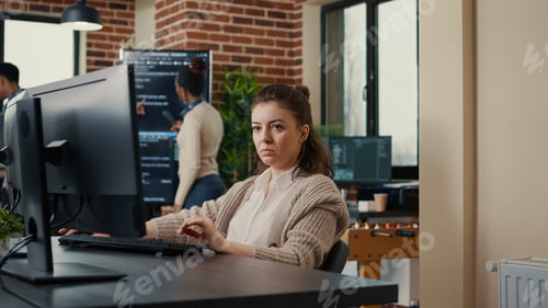 Preview: Software engineers analyzing code on wall screen tv looking for bugs and errors while colleague