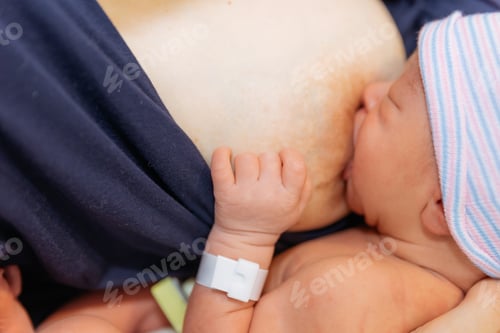 Preview: Newborn baby being breast fed by mother in hospital