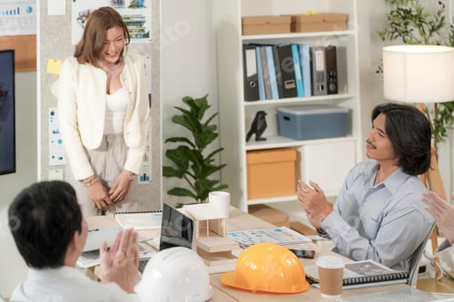 Preview: businesswoman receives applause after presenting sustainable architectural design