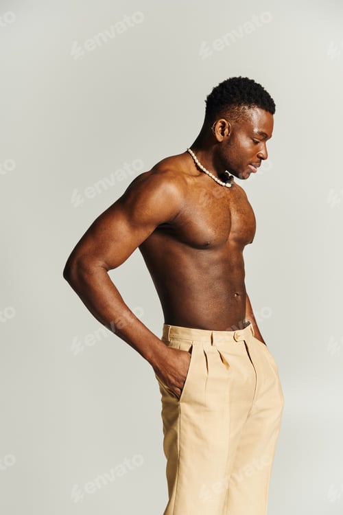 Preview: Handsome young man confidently poses topless, exuding charisma in a stylish contemporary setting