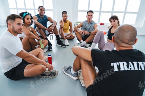 Preview: Group of athletes listening to their trainer after functional training workout