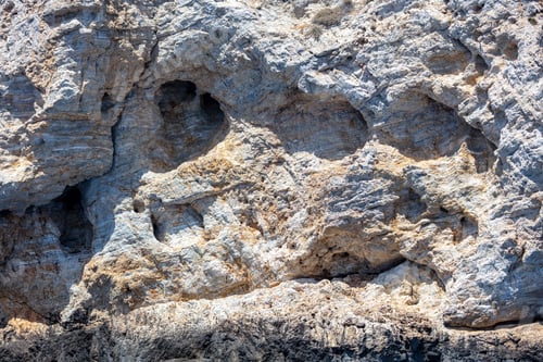 Preview: Grey rock background texture. Stone formation, rough natural material shaped by the sea, salt wind