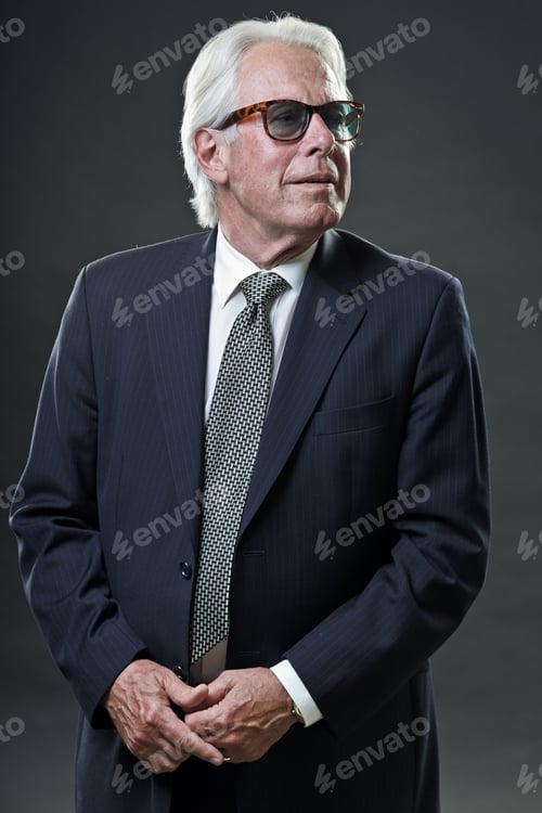 Preview: Studio Portrait Of Senior Business Man With Sunglasses Looking Confident.