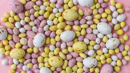Preview: Stylish colorful candy easter eggs flat lay on pink background. Chocolate eggs, easter background