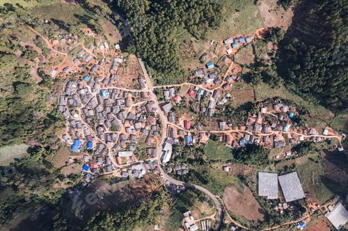 Preview: Aerial view of local rural village in the valley on faraway at countryside