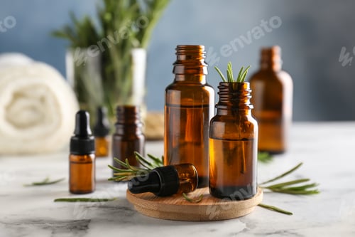 Preview: Bottles with rosemary essential oil on table