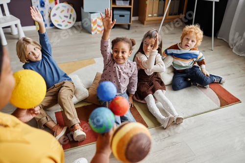Preview: Enthusiastic Children Playfully Raise Hands in Classroom Setting