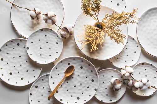 Preview: Beautiful plates on a white background with cotton. Beautiful layout