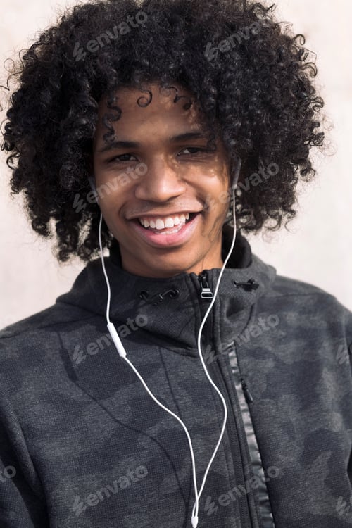 Preview: teenage boy enjoying music with earphones