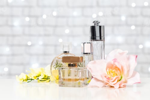 Preview: Elegant perfume bottles arranged with beautiful flowers on a stylish background