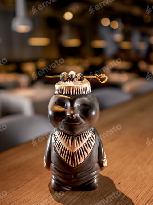 Preview: Tropical tiki cocktail on bar counter in nightclub