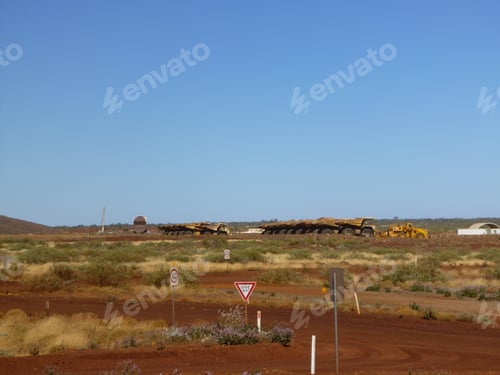 Preview: Industrial cars on the road surrounded by grass