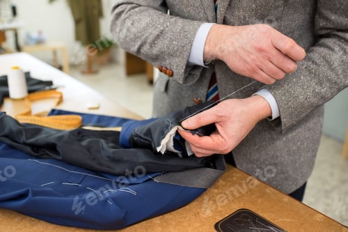 Preview: Work in progress with a tailor sewing a jacket