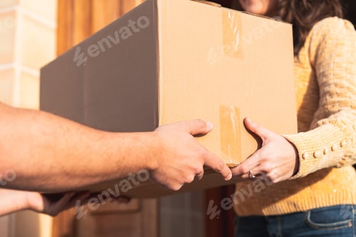 Preview: Courier delivering cardboard package to customer receiving order