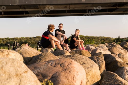 Preview: Three cyclists by bridge