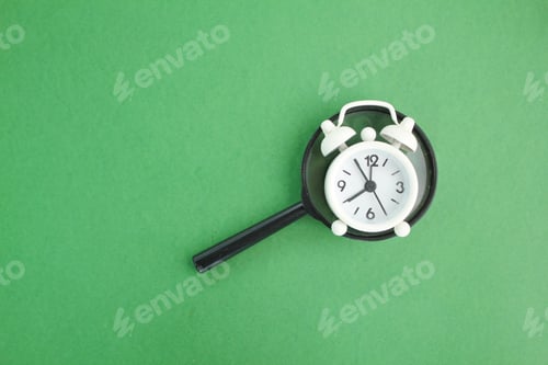 Preview: magnifying glass and bell clock. the concept of finding time or time is gold.