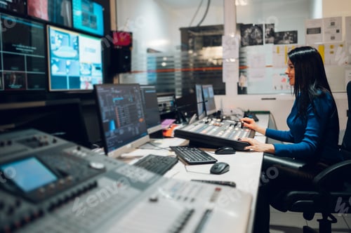 Preview: Middle aged woman using equipment in control room on a tv station